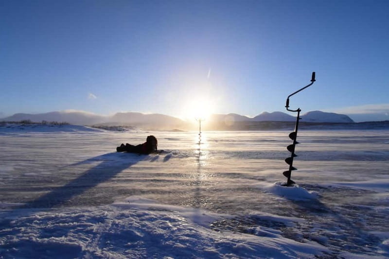 Abisko: Ice Fishing Experience - Drilling Through the Ice Near Abisko