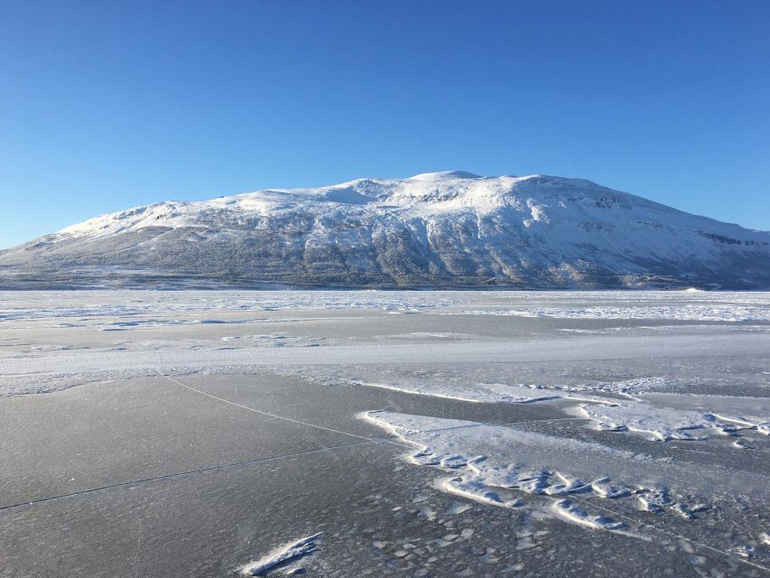 Abisko: Lake Torneträsk Arctic Ice Fishing Trip - Sitting on Arctic ice near Abisko