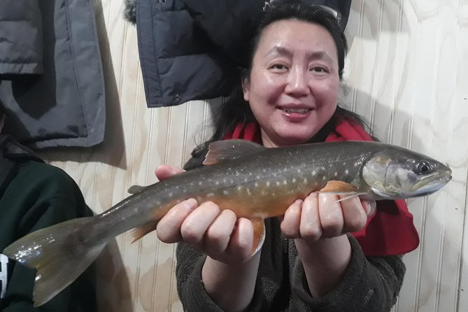 Fairbanks Ice Fishing Expedition in a Heated Cabin with Fish Cookout - Looking beneath the ice for salmon and trout