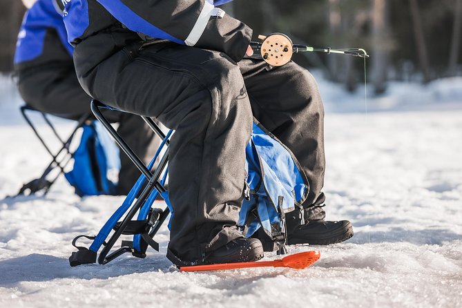 Ice Fishing Tour - Drilling through the ice and setting up