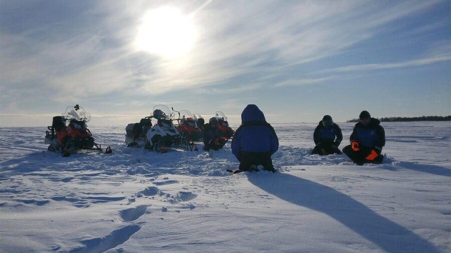 Kemi-Tornio: Ice Fishing Safari with Snowmobiles - Drilling through sea ice for the fishing stop