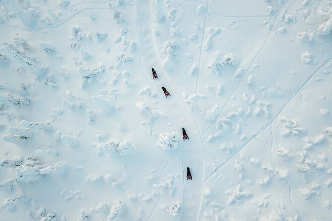 Lappish Lunch Break -Snowmobiling, ice fishing and tasty food - Riding through the snowy Finnish wilderness