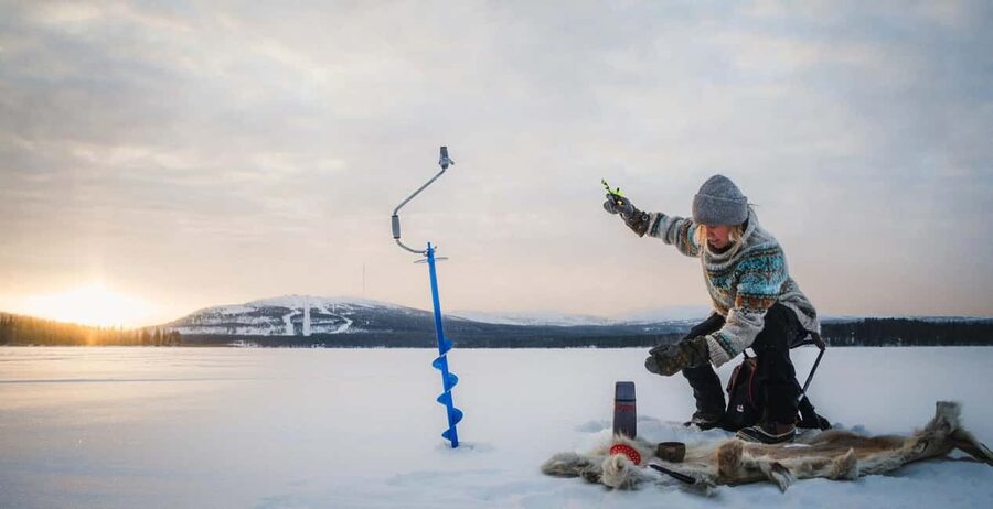 Pyhä: Ice Fishing Experience at Frozen Lake - Drilling through the ice and setting your line