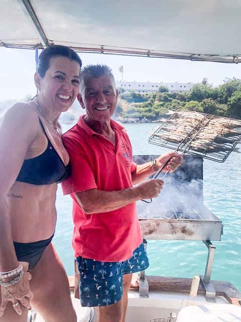 Rhodes: Captain Manolis Fishing Trip with BBQ and Swimming - Swimming near a beach in the Aegean