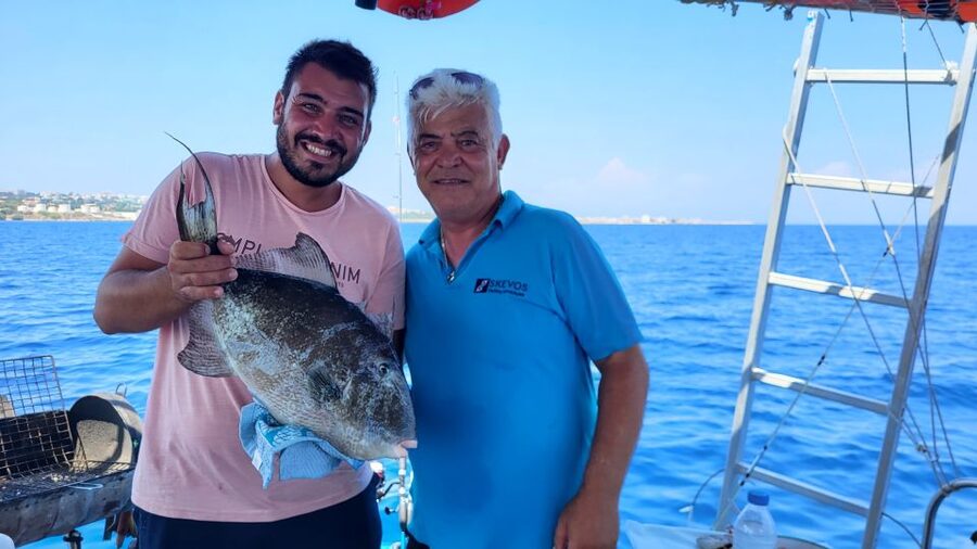 Rhodes: Fishing Trip, Snorkelling, BBQ, & Professional Guide - What the traditional wooden boat is like