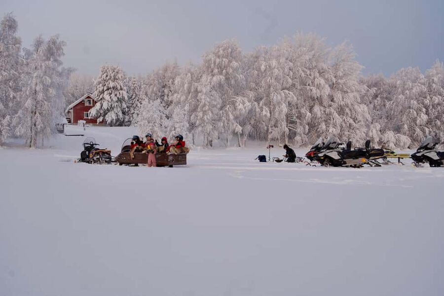 Rovaniemi: Ice Fishing and Snowmobile Tour with Snacks - Riding a Snowmobile Across the Frozen Lake