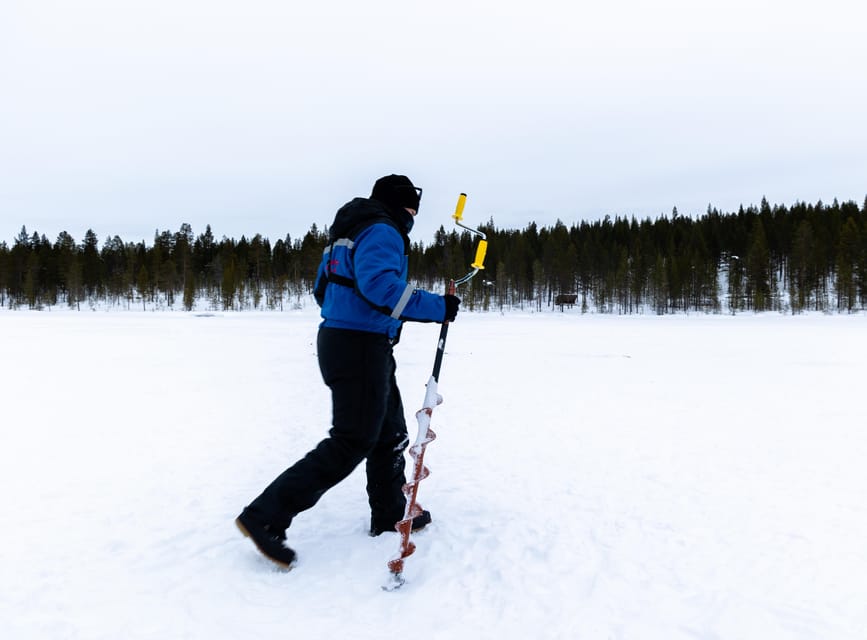 Saariselkä: Ice Fishing Safari by Snowmobile - Drilling a hole in the ice