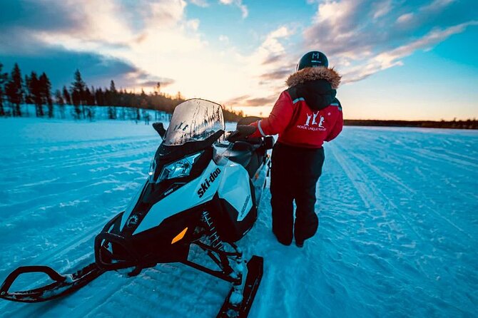 Snowmobile and Ice Fishing Experience - Drilling into a frozen Arctic lake